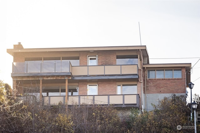 rear view of property featuring a balcony