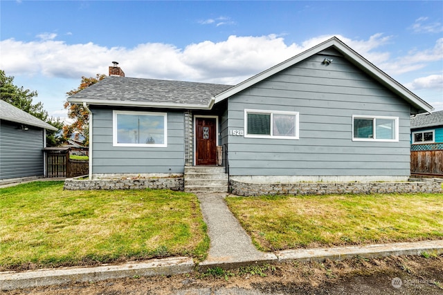 bungalow-style home with a front lawn