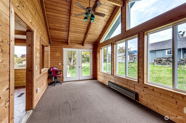 unfurnished sunroom with ceiling fan, a wealth of natural light, vaulted ceiling with beams, and a baseboard heating unit