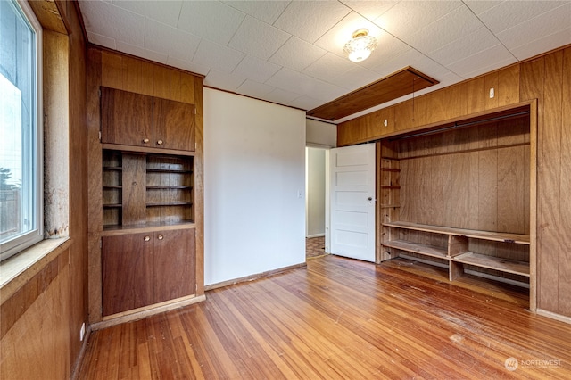 interior space featuring light hardwood / wood-style floors and wood walls