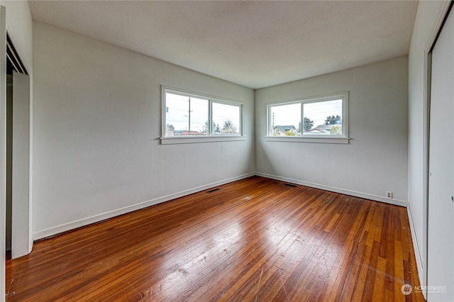 unfurnished bedroom with hardwood / wood-style flooring