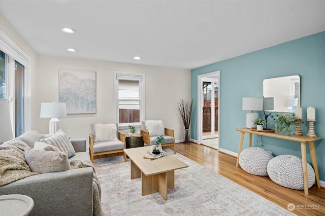 living room with light wood-type flooring and a healthy amount of sunlight