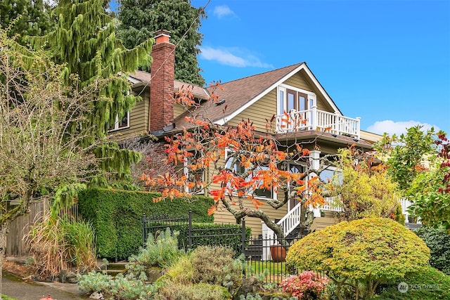 rear view of house featuring a balcony