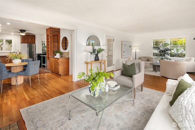 living room featuring light hardwood / wood-style flooring and ceiling fan