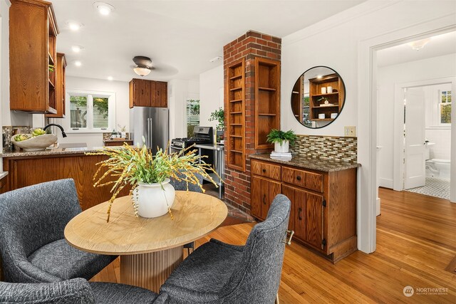 dining space featuring crown molding and light hardwood / wood-style flooring