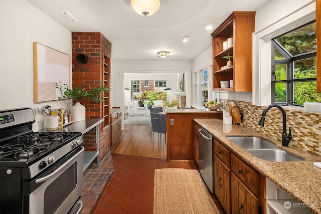 kitchen with dark hardwood / wood-style floors, stainless steel appliances, sink, and plenty of natural light