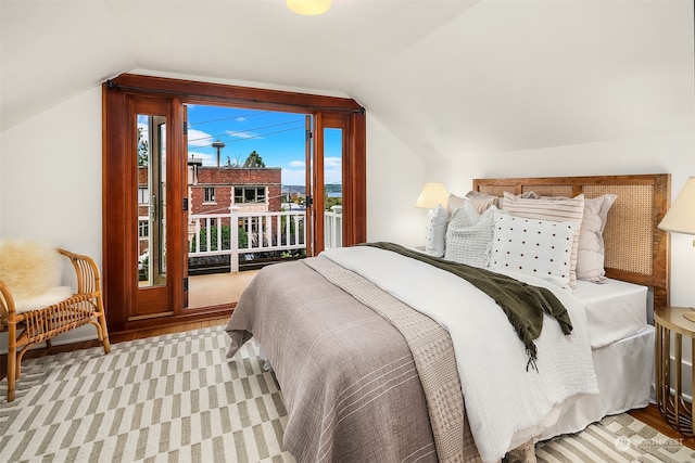 bedroom featuring light hardwood / wood-style floors and lofted ceiling