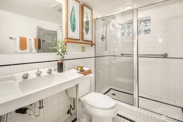 bathroom with toilet, tile walls, tile patterned flooring, and an enclosed shower