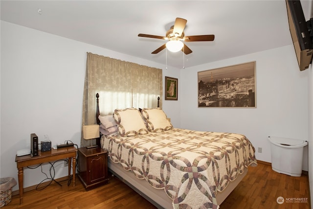 bedroom with ceiling fan and dark hardwood / wood-style flooring