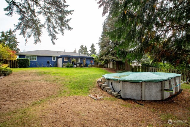 view of yard featuring a covered pool