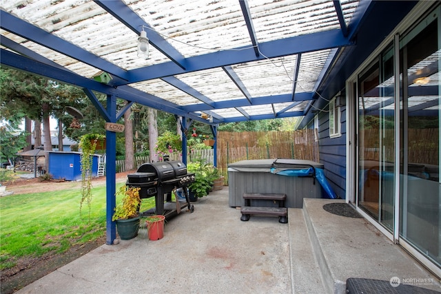 view of patio / terrace featuring a hot tub, a storage shed, and a pergola