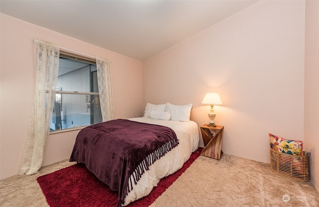 carpeted bedroom featuring vaulted ceiling