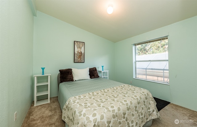 carpeted bedroom with vaulted ceiling