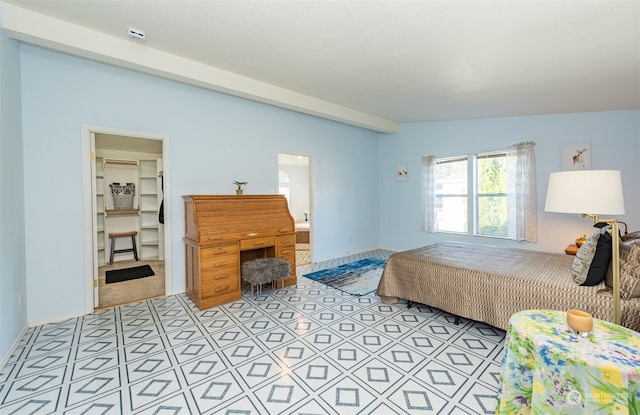 bedroom featuring lofted ceiling and connected bathroom