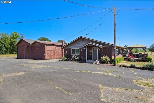 view of front of property featuring a garage and an outdoor structure