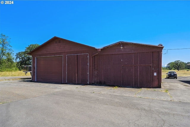 garage featuring wood walls