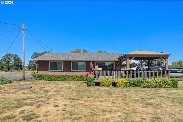 ranch-style house with a gazebo, a front yard, and a deck