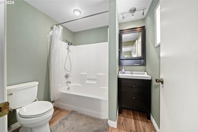 full bathroom with vanity, toilet, shower / bathtub combination with curtain, and hardwood / wood-style floors