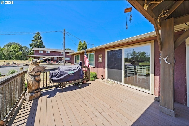 wooden terrace featuring a grill