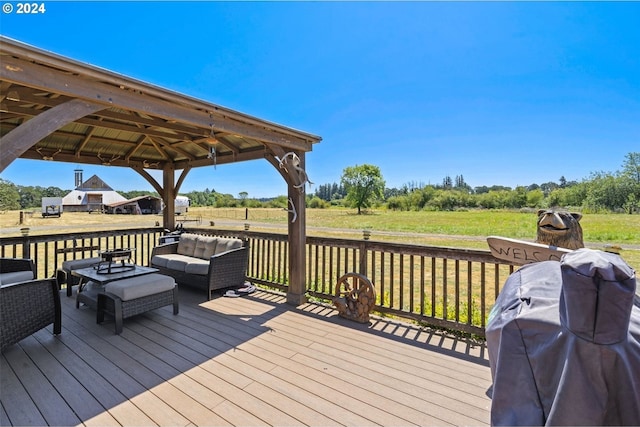 wooden terrace with a rural view, a gazebo, a yard, and grilling area