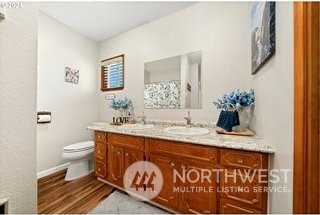 bathroom featuring vanity, toilet, and hardwood / wood-style flooring