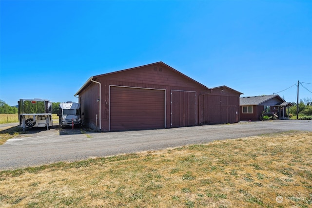 garage featuring a lawn