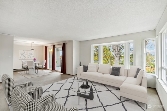 living room with a baseboard heating unit, a textured ceiling, a healthy amount of sunlight, and light colored carpet