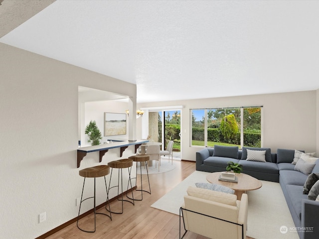 living room featuring a textured ceiling and light wood-type flooring