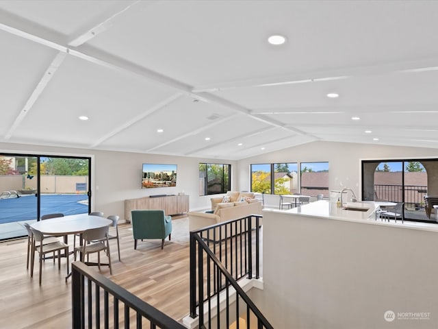 interior space featuring light hardwood / wood-style floors and lofted ceiling