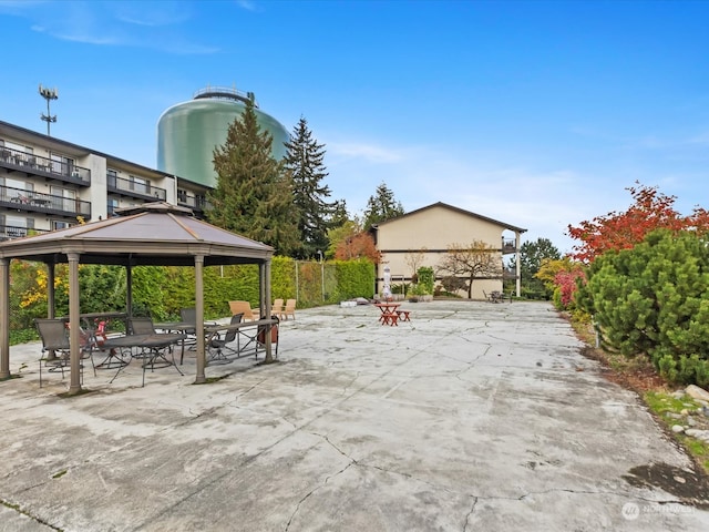 view of patio featuring a gazebo and a balcony