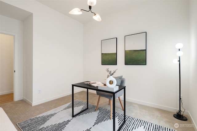 carpeted home office with a notable chandelier