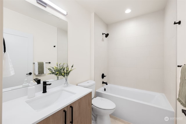 full bathroom featuring vanity, tiled shower / bath combo, and toilet