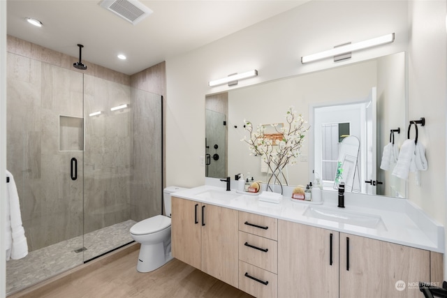 bathroom with vanity, toilet, hardwood / wood-style flooring, and walk in shower