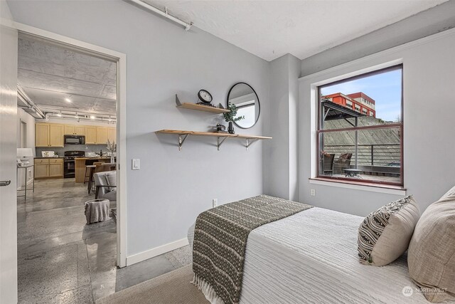 744 Market St Unit 202, Tacoma, WA 98402 - bedroom with baseboards and finished concrete floors