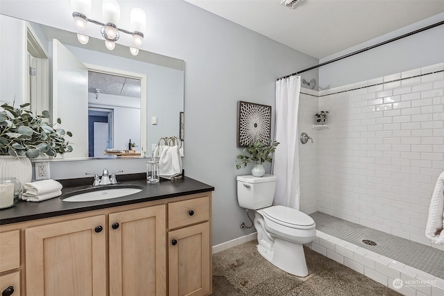 bathroom featuring curtained shower, vanity, and toilet