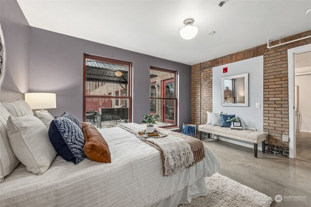 744 Market St Unit 202, Tacoma, WA 98402 - bedroom with finished concrete floors and brick wall