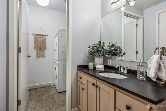 744 Market St Unit 202, Tacoma, WA 98402 - bathroom with stacked washing machine and dryer, vanity, and baseboards