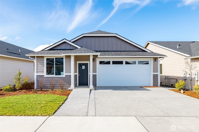 view of front facade featuring an attached garage, board and batten siding, concrete driveway, and roof with shingles