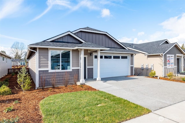 view of front of property featuring a garage, driveway, board and batten siding, and roof with shingles