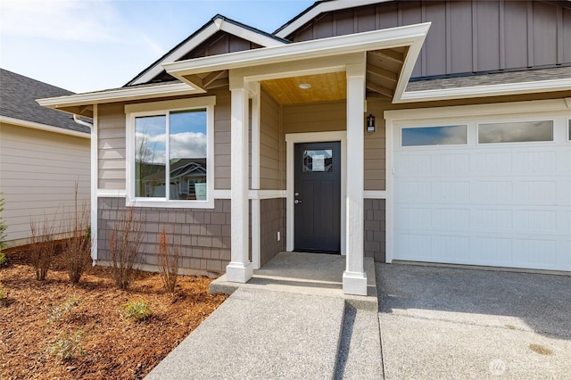 view of exterior entry with board and batten siding and a shingled roof