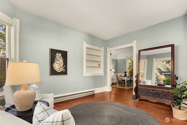 sitting room with a baseboard radiator and dark hardwood / wood-style flooring