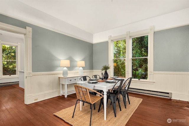 dining space featuring dark hardwood / wood-style floors and a baseboard heating unit