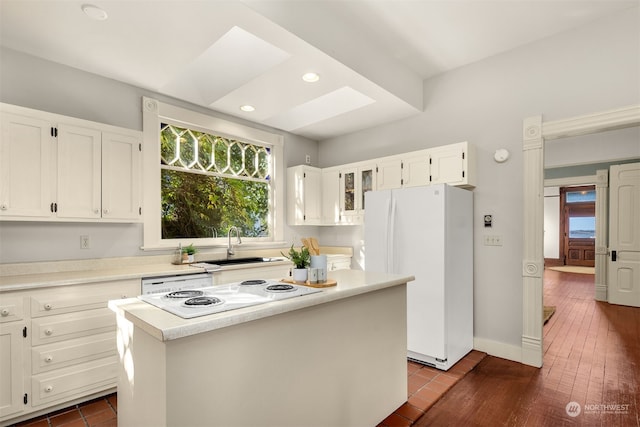 kitchen with white appliances, sink, a kitchen island, white cabinetry, and dark wood-type flooring