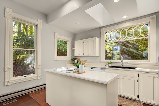 kitchen with a kitchen island, white dishwasher, sink, a baseboard radiator, and white cabinetry