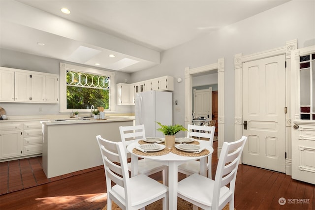 dining space with dark hardwood / wood-style floors