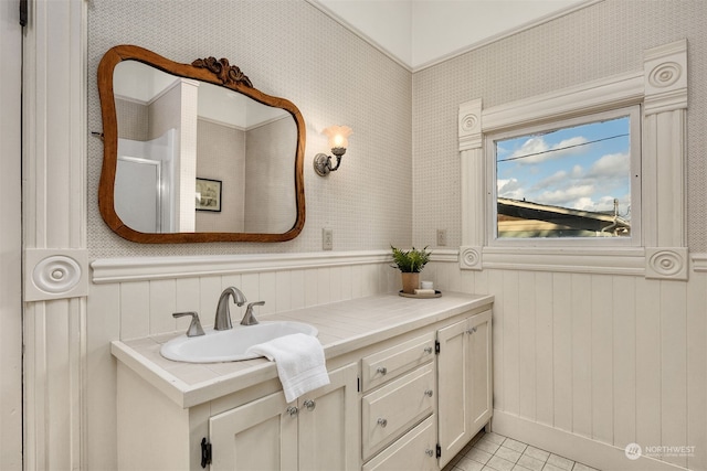 bathroom featuring vanity, wood walls, and tile patterned flooring