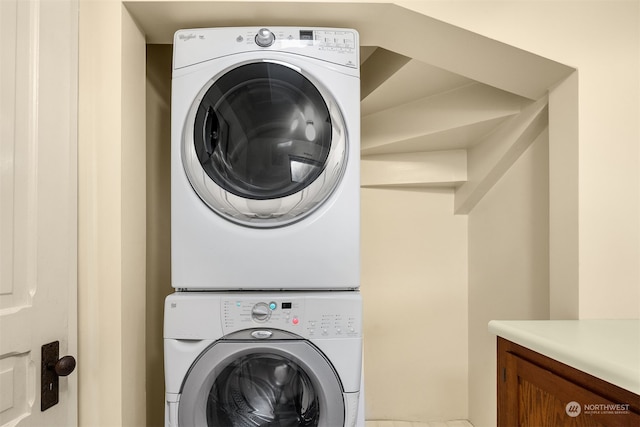 clothes washing area featuring stacked washer and dryer