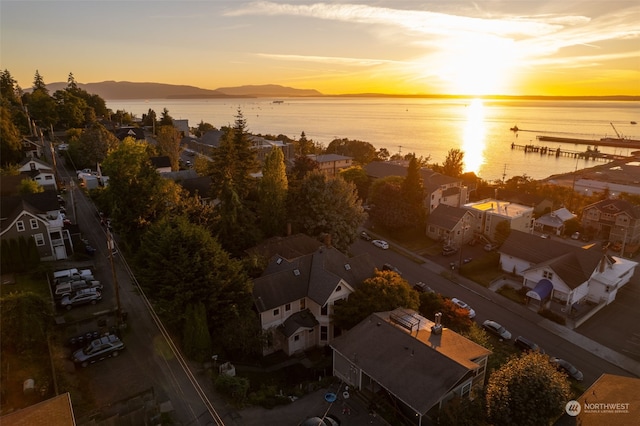 aerial view at dusk with a water and mountain view