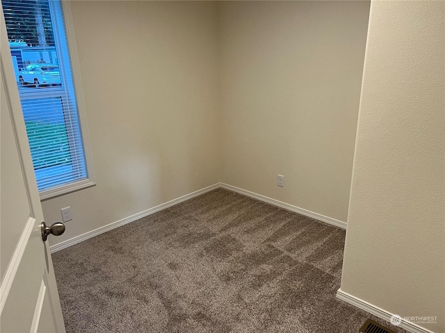 507 131st St E Unit L, Tacoma, WA 98445 - empty room with dark carpet and baseboards
