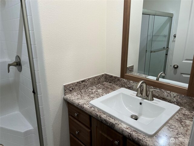 507 131st St E Unit L, Tacoma, WA 98445 - full bath with a shower stall, vanity, and a textured wall